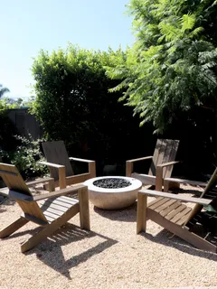 a view of a patio with table and chairs and potted plants