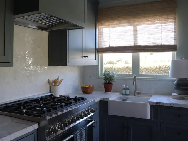 a kitchen with stainless steel appliances a sink a stove and a window