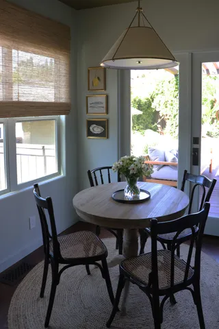 a view of a dining room with furniture and window