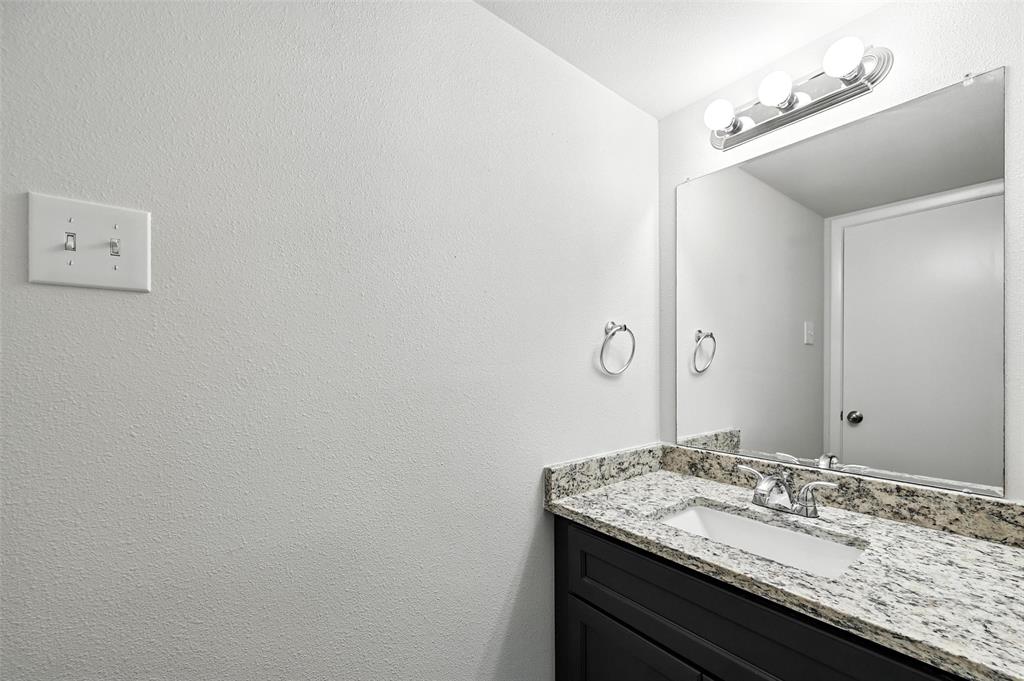 5626 Preston Oaks Road, Unit 22C Dallas, TX 75254 - Photo 18 of 29 a bathroom with a granite countertop sink and a mirror