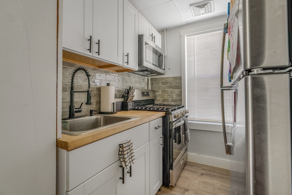 500 Birch Street Fall River, MA 02724 - Photo 21 of 35 a kitchen with stainless steel appliances granite countertop a refrigerator and a sink