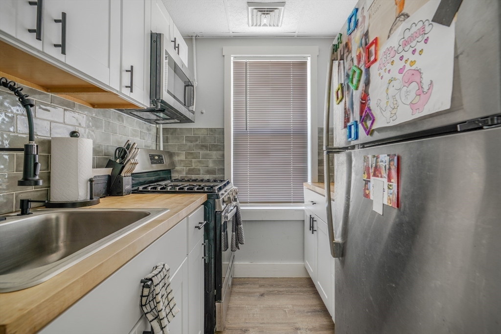 500 Birch Street Fall River, MA 02724 - Photo 22 of 35 a kitchen with stainless steel appliances granite countertop a refrigerator and a sink