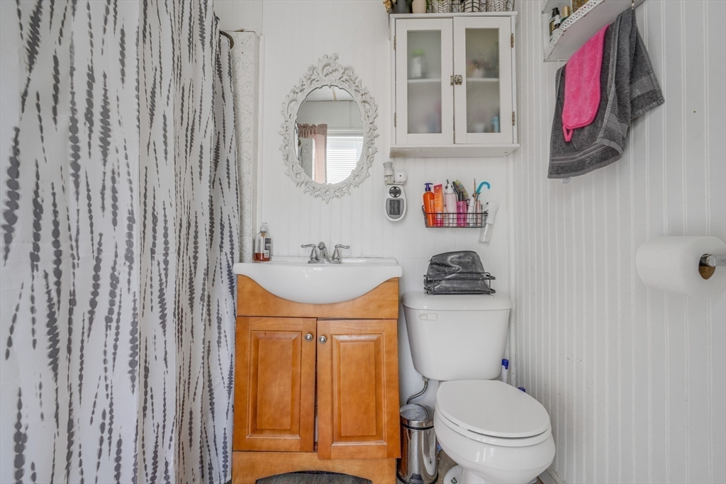 500 Birch Street Fall River, MA 02724 - Photo 29 of 35 a bathroom with a toilet sink and mirror