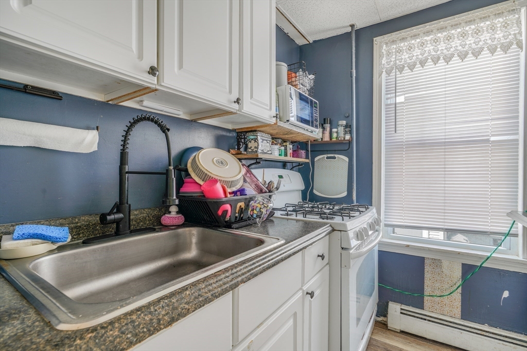 500 Birch Street Fall River, MA 02724 - Photo 34 of 35 a kitchen with stainless steel appliances granite countertop a sink and a white cabinets