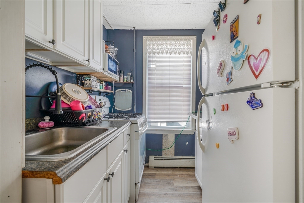 500 Birch Street Fall River, MA 02724 - Photo 35 of 35 a kitchen with a sink stove and refrigerator