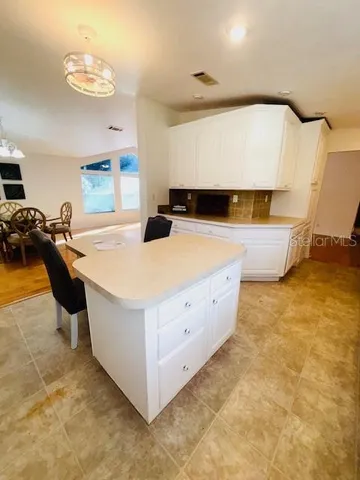 a living room with a table and chairs