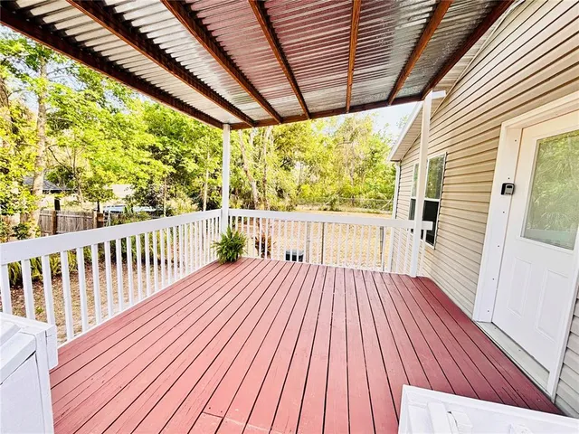 a view of a field with trees in the background