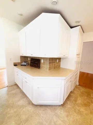 a spacious bedroom with a bed and a window