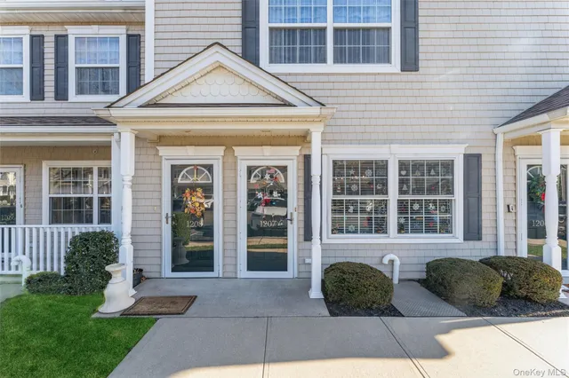 a front view of a house with garden and porch