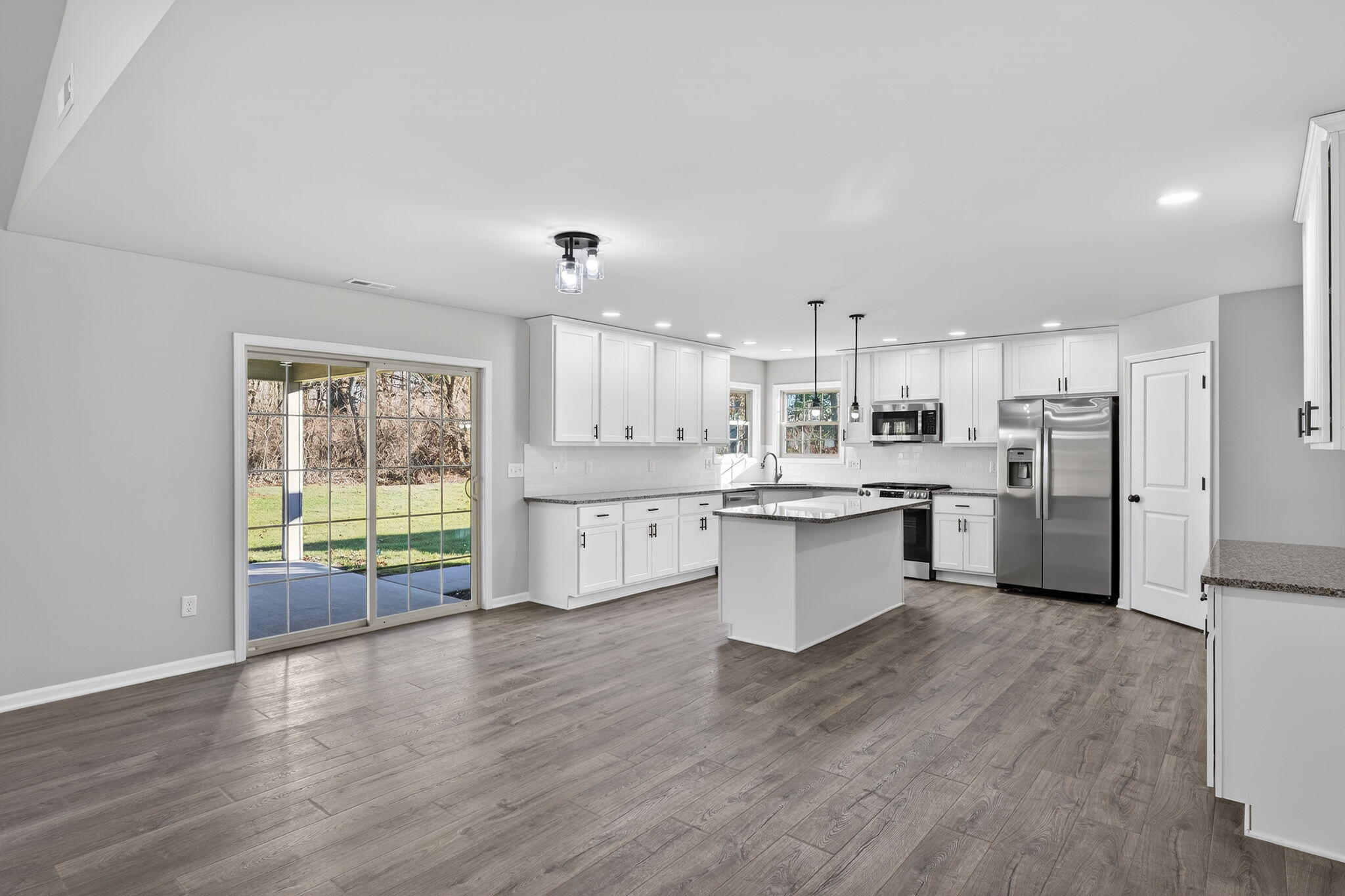 1611 Elderberry Street Southeast De Motte, IN 46310 - Photo 11 of 31 a large kitchen with a large counter top a sink stainless steel appliances and cabinets