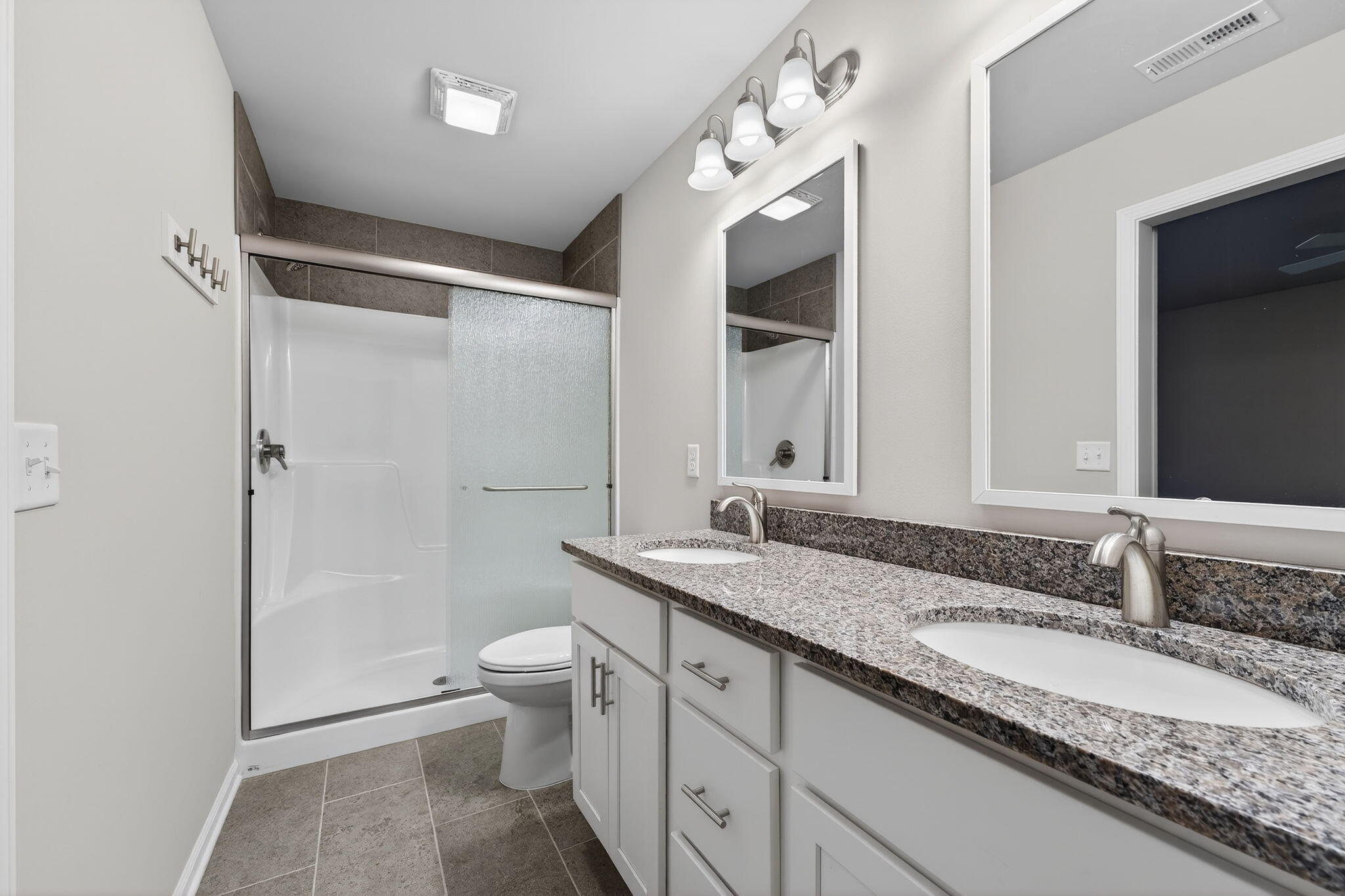 1611 Elderberry Street Southeast De Motte, IN 46310 - Photo 24 of 31 a bathroom with a granite countertop sink toilet and shower