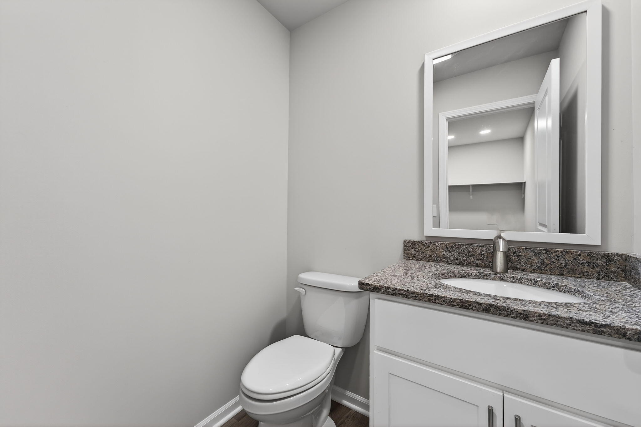 1611 Elderberry Street Southeast De Motte, IN 46310 - Photo 27 of 31 a bathroom with a granite countertop toilet and a sink