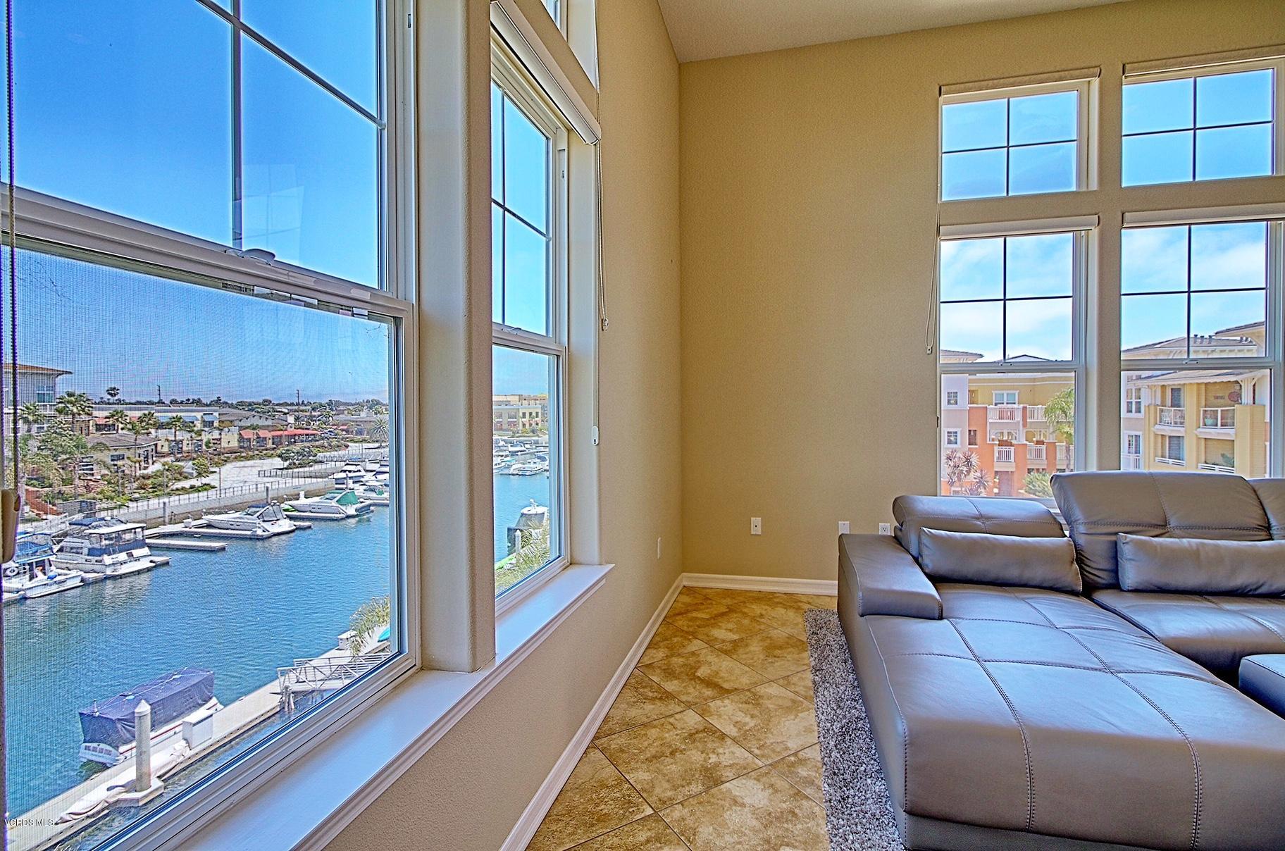 1568 Seabridge Lane Oxnard, CA 93035 - Photo 12 of 33 a living room with furniture and floor to ceiling windows