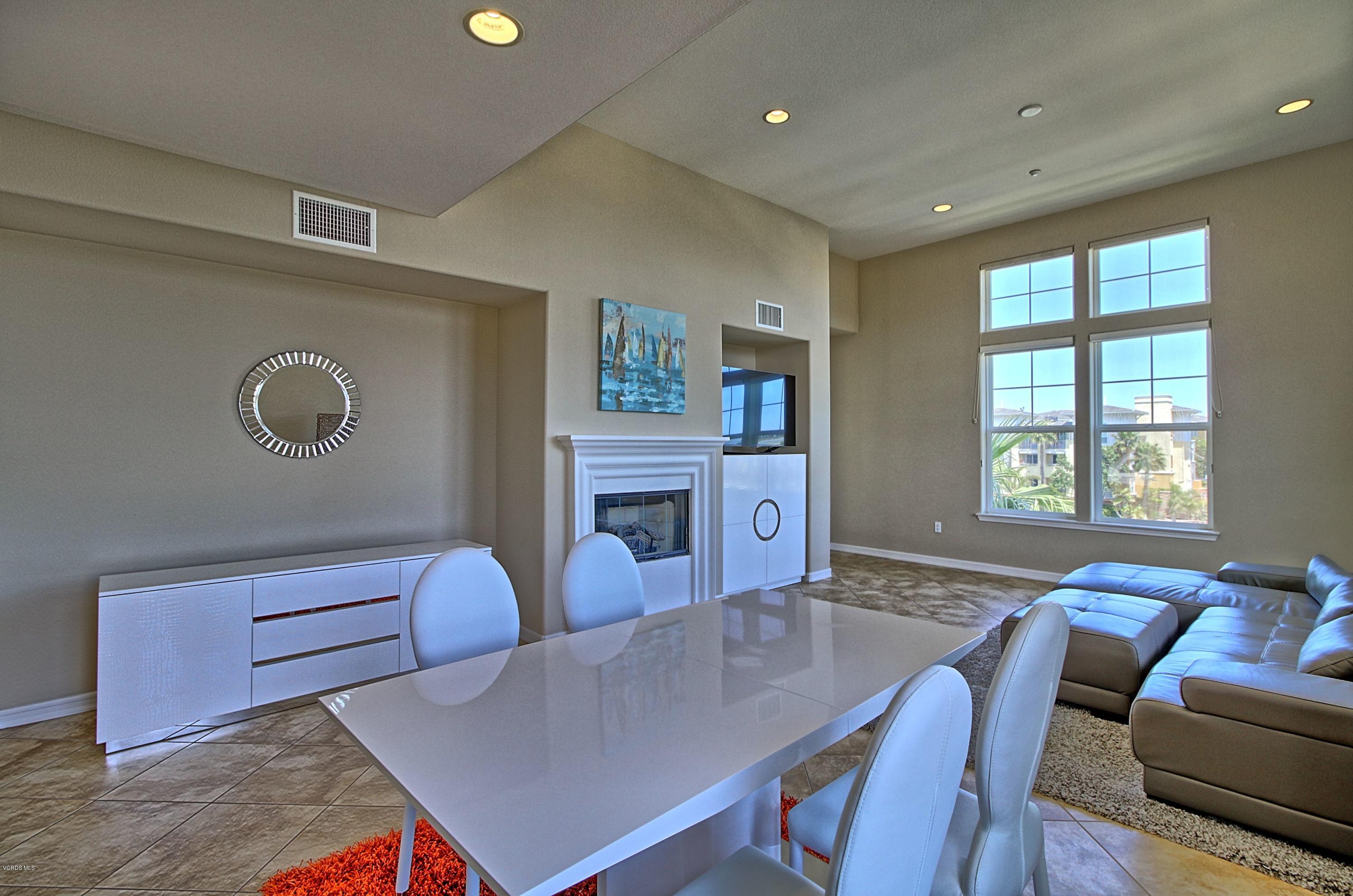 1568 Seabridge Lane Oxnard, CA 93035 - Photo 13 of 33 a living room with furniture a chandelier and a table