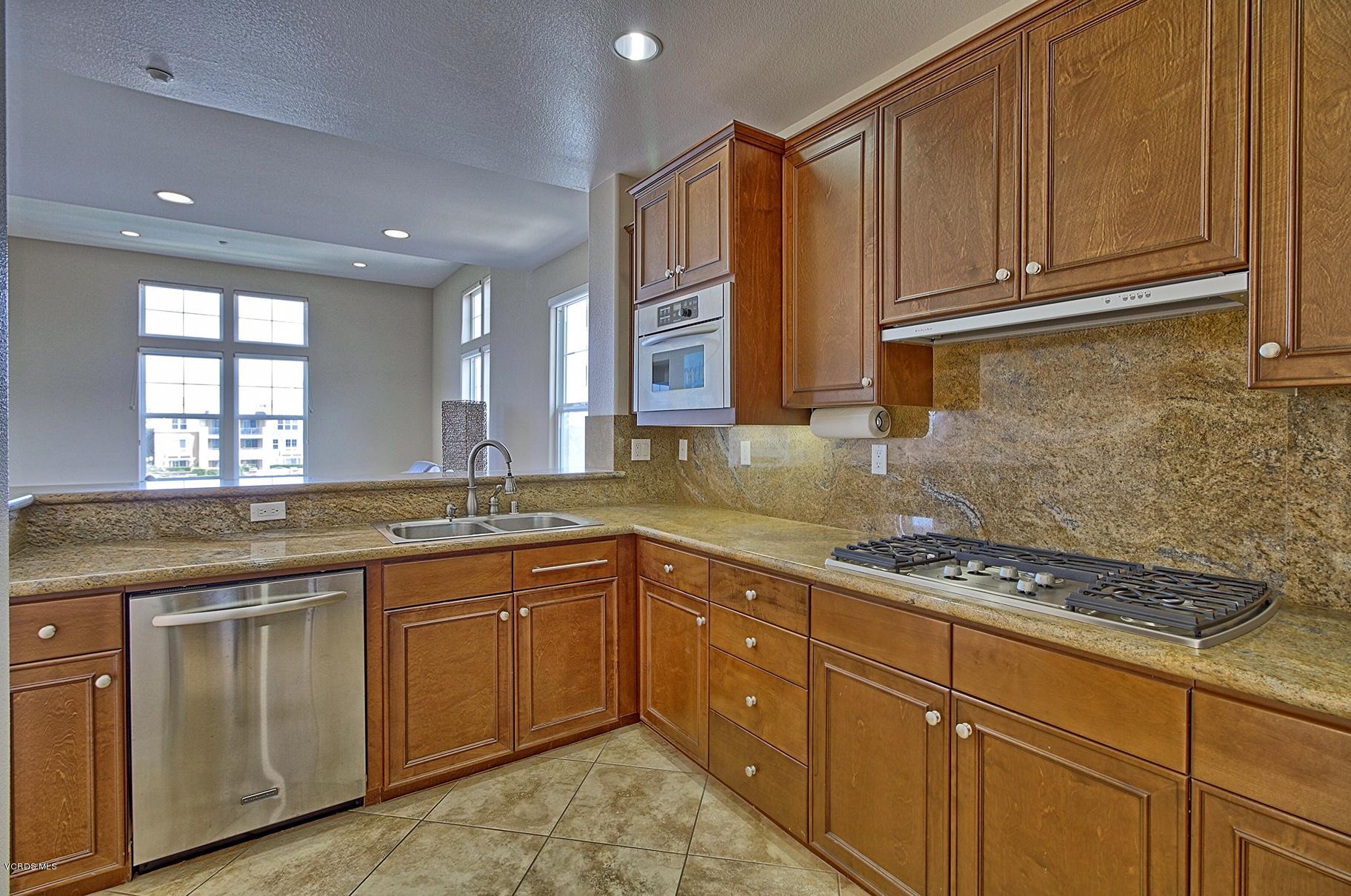 1568 Seabridge Lane Oxnard, CA 93035 - Photo 15 of 33 a kitchen with stainless steel appliances granite countertop a sink stove and cabinets