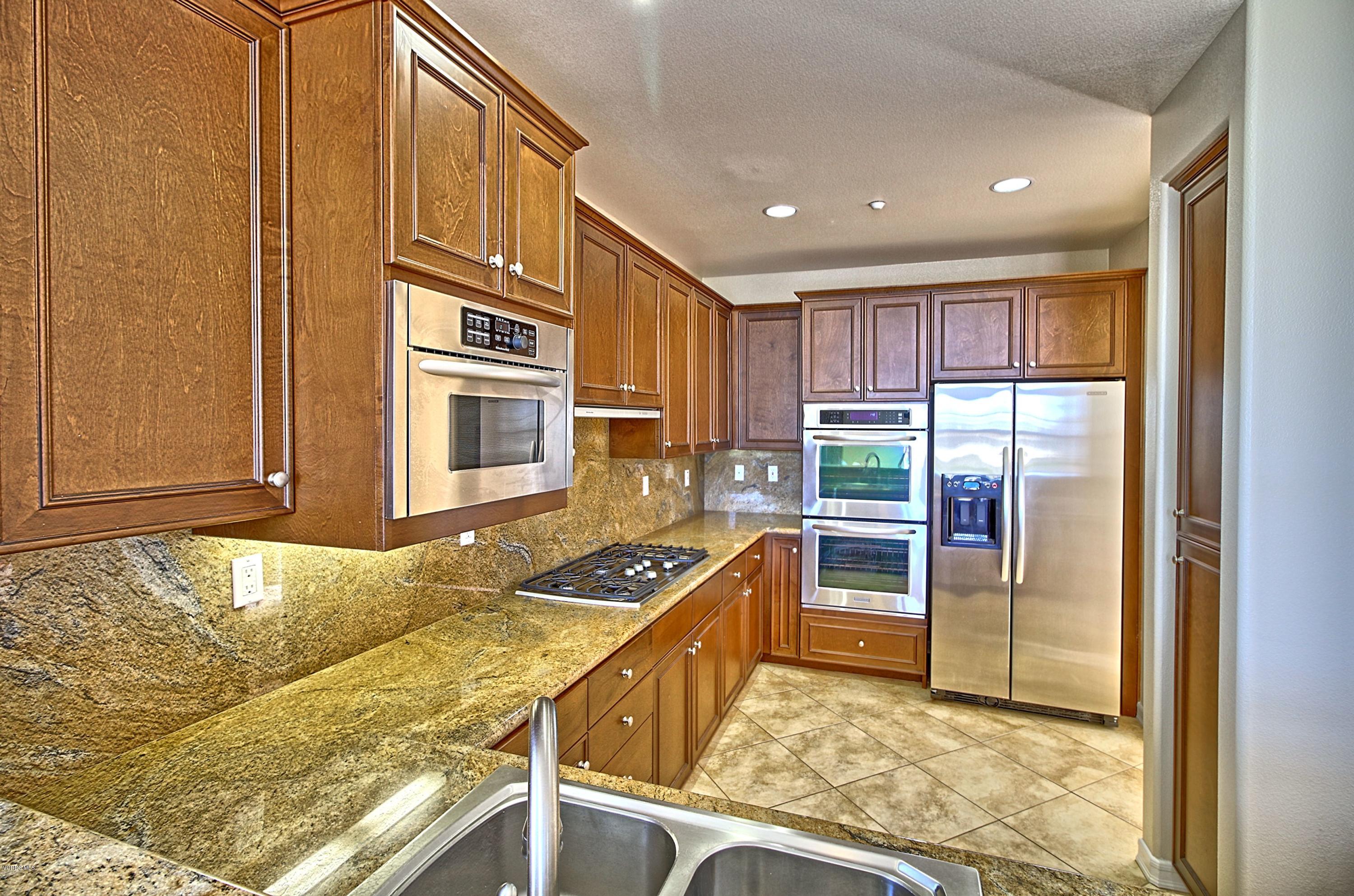 1568 Seabridge Lane Oxnard, CA 93035 - Photo 17 of 33 a kitchen with stainless steel appliances granite countertop a refrigerator and a stove top oven