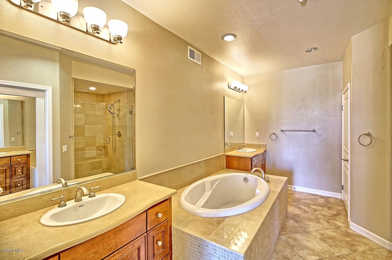 1568 Seabridge Lane Oxnard, CA 93035 - Photo 19 of 33 a bathroom with a sink double vanity granite tub shower and a mirror
