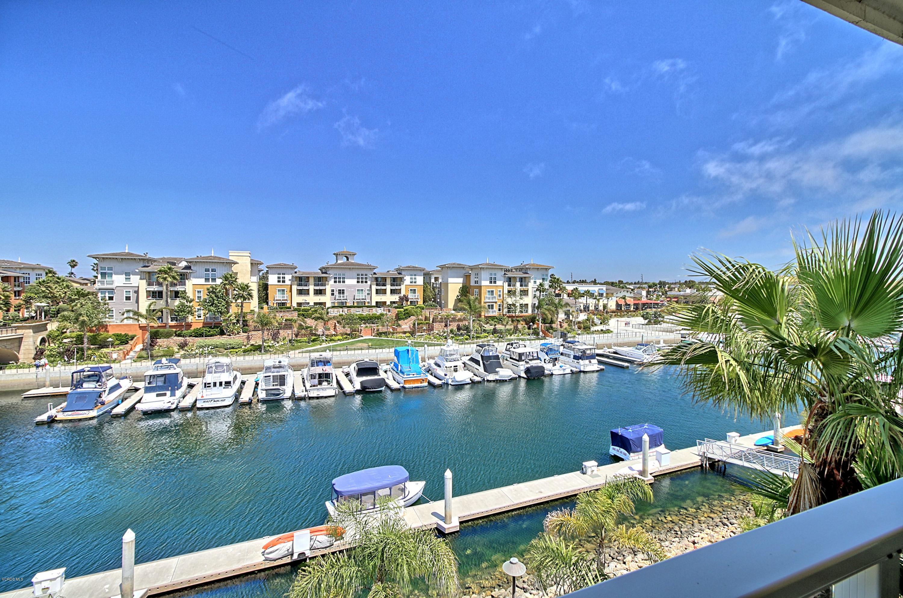 1568 Seabridge Lane Oxnard, CA 93035 - Photo 3 of 33 a view of a lake with boats and trees in the background