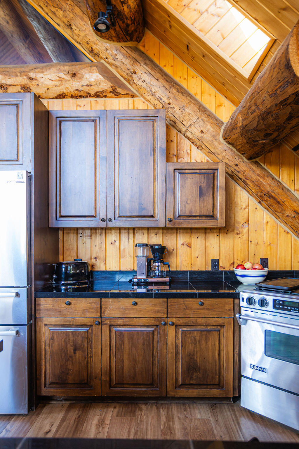 2335 County Road Placerville, CO 81430 - Photo 21 of 38 a kitchen with granite countertop wooden cabinets and a stove top oven