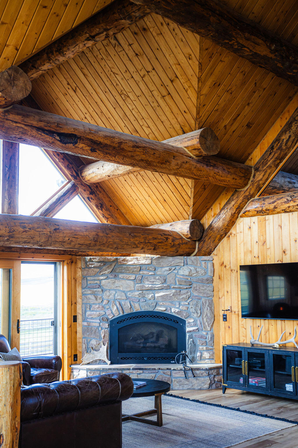 2335 County Road Placerville, CO 81430 - Photo 23 of 38 a living room with furniture a flat screen tv and a fireplace