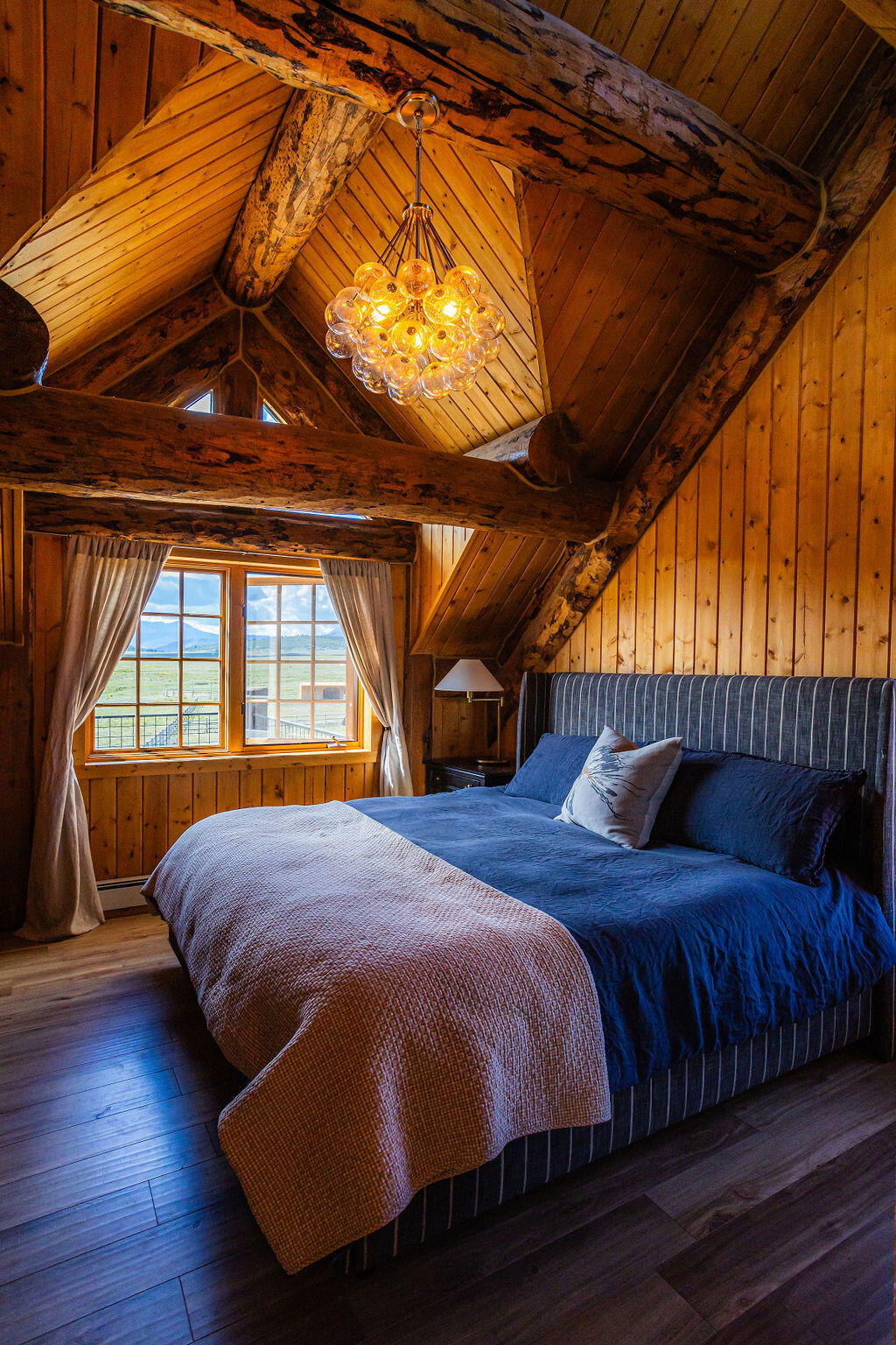 2335 County Road Placerville, CO 81430 - Photo 25 of 38 a bed sitting in a bedroom next to a window