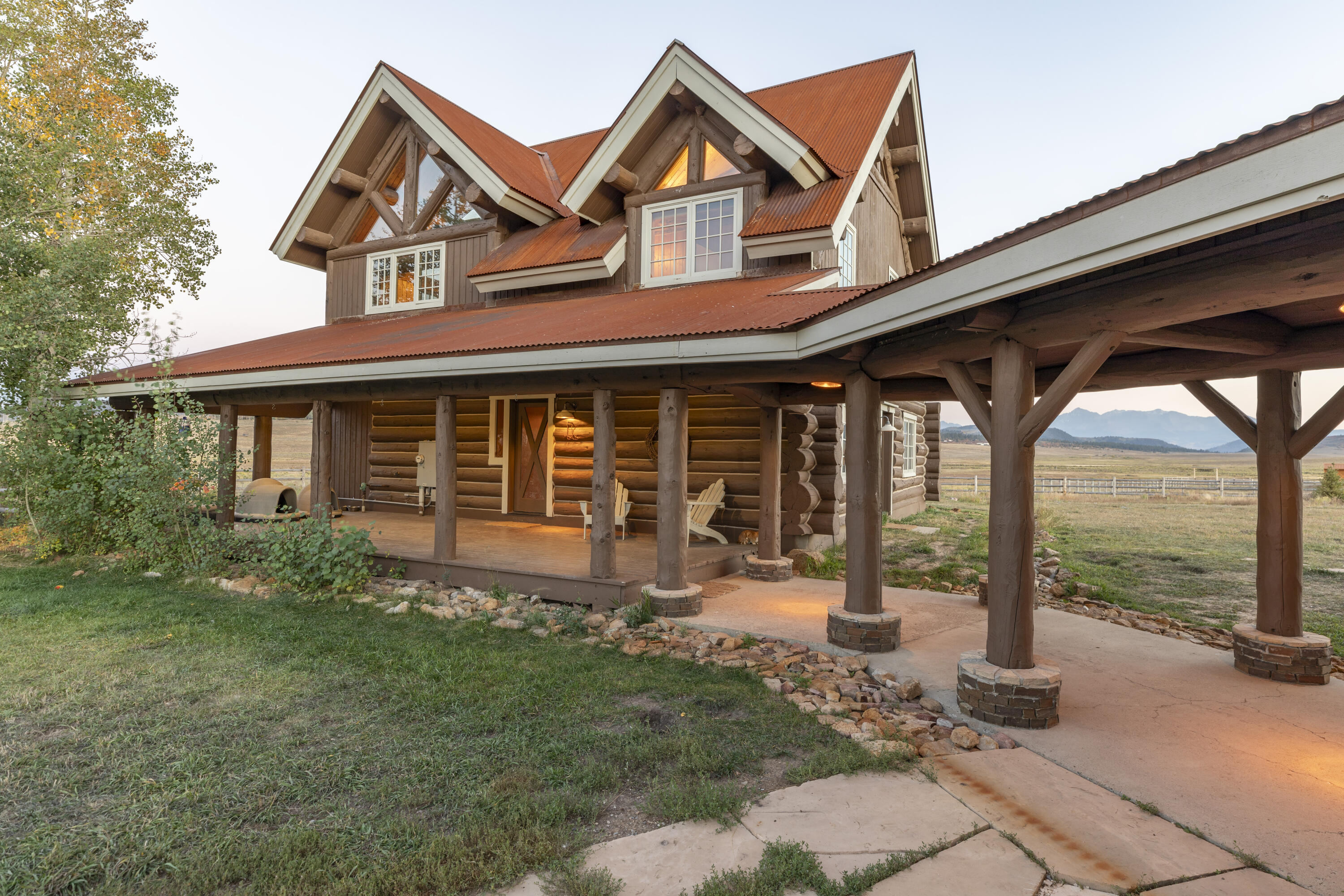 2335 County Road Placerville, CO 81430 - Photo 5 of 38 a front view of a house with yard and porch