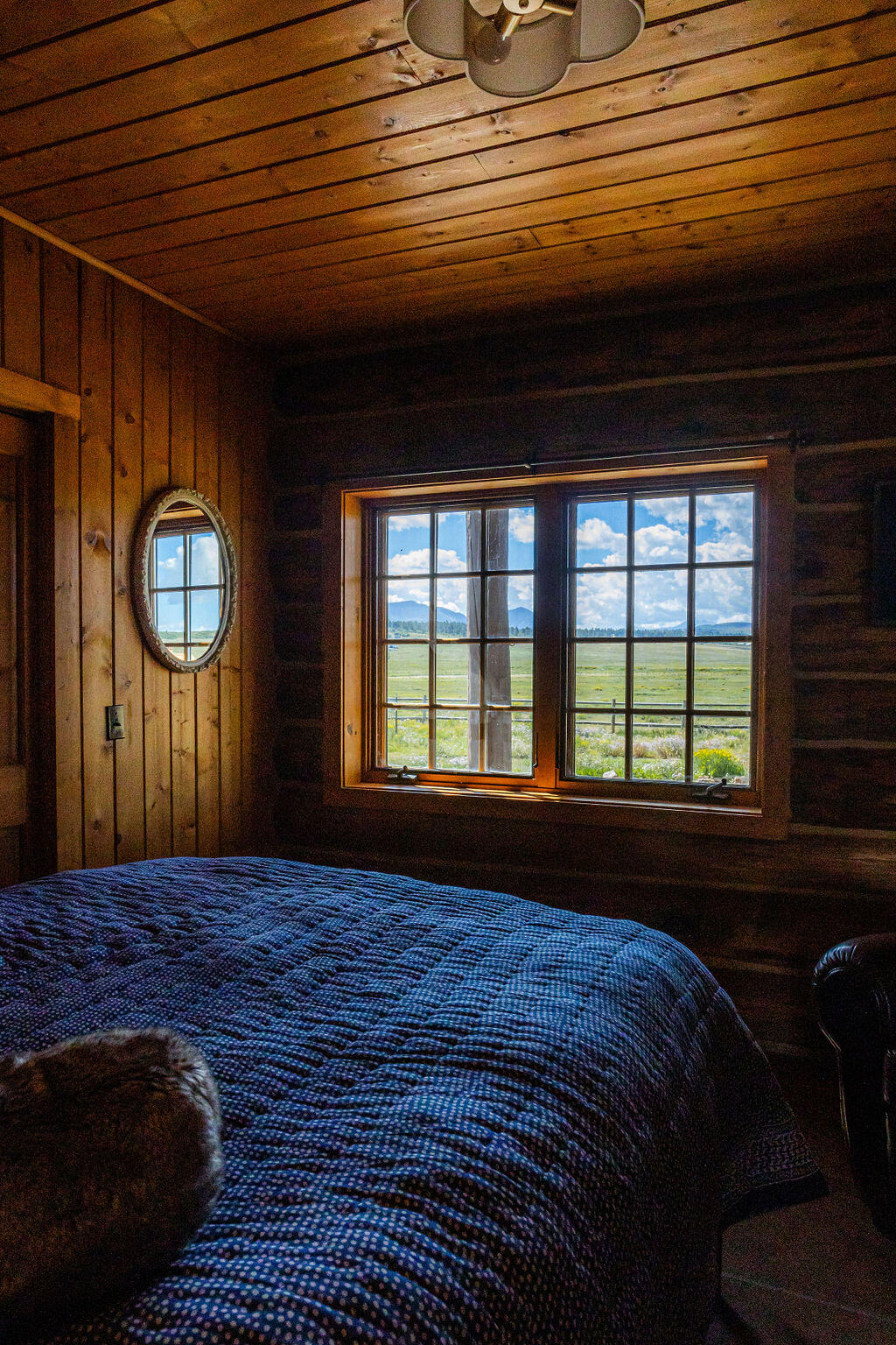 2335 County Road Placerville, CO 81430 - Photo 8 of 38 a bed sitting in a bedroom next to a window