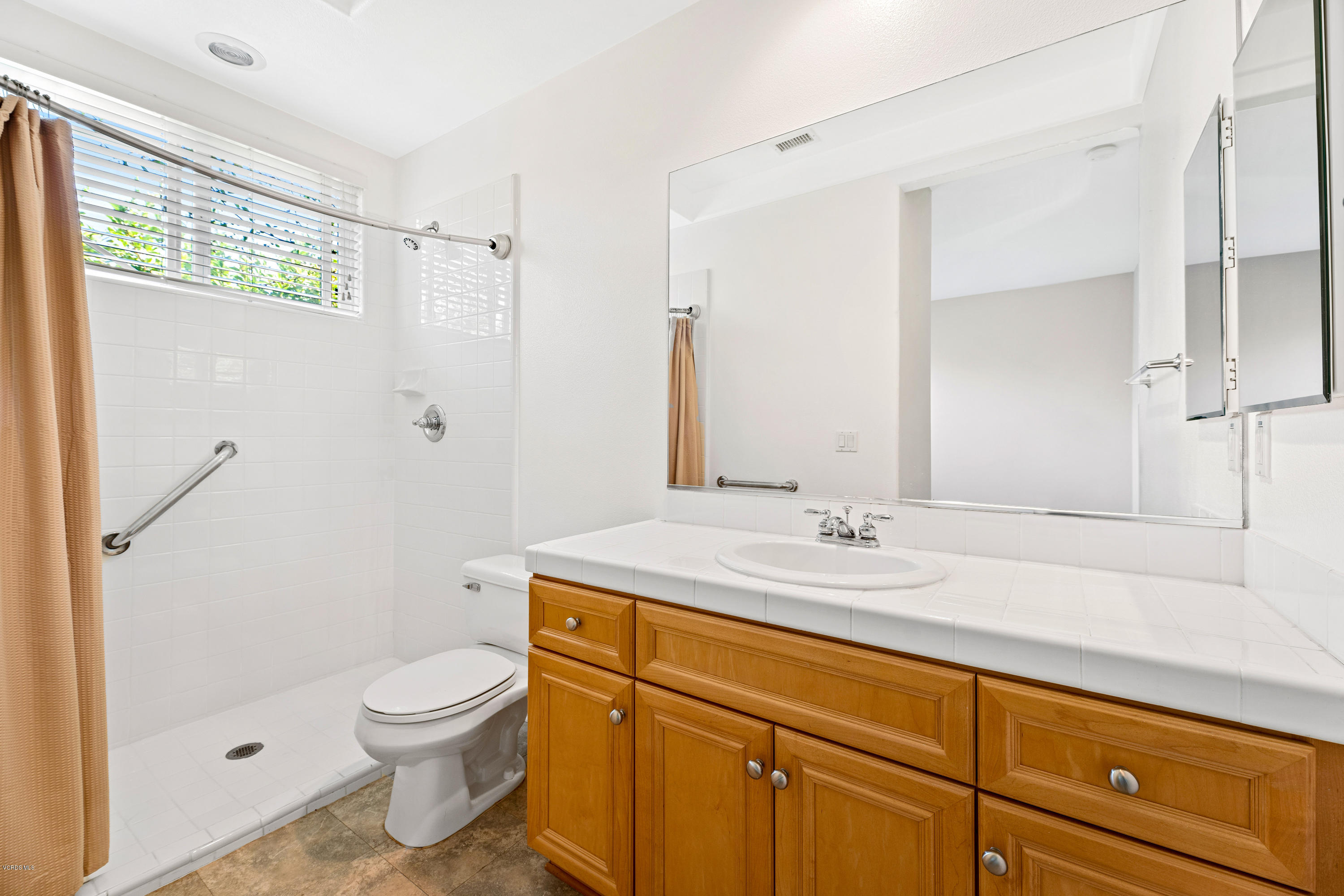 4591 Bluewood Court Moorpark, CA 93021 - Photo 11 of 43 a bathroom with a granite countertop sink a toilet and shower