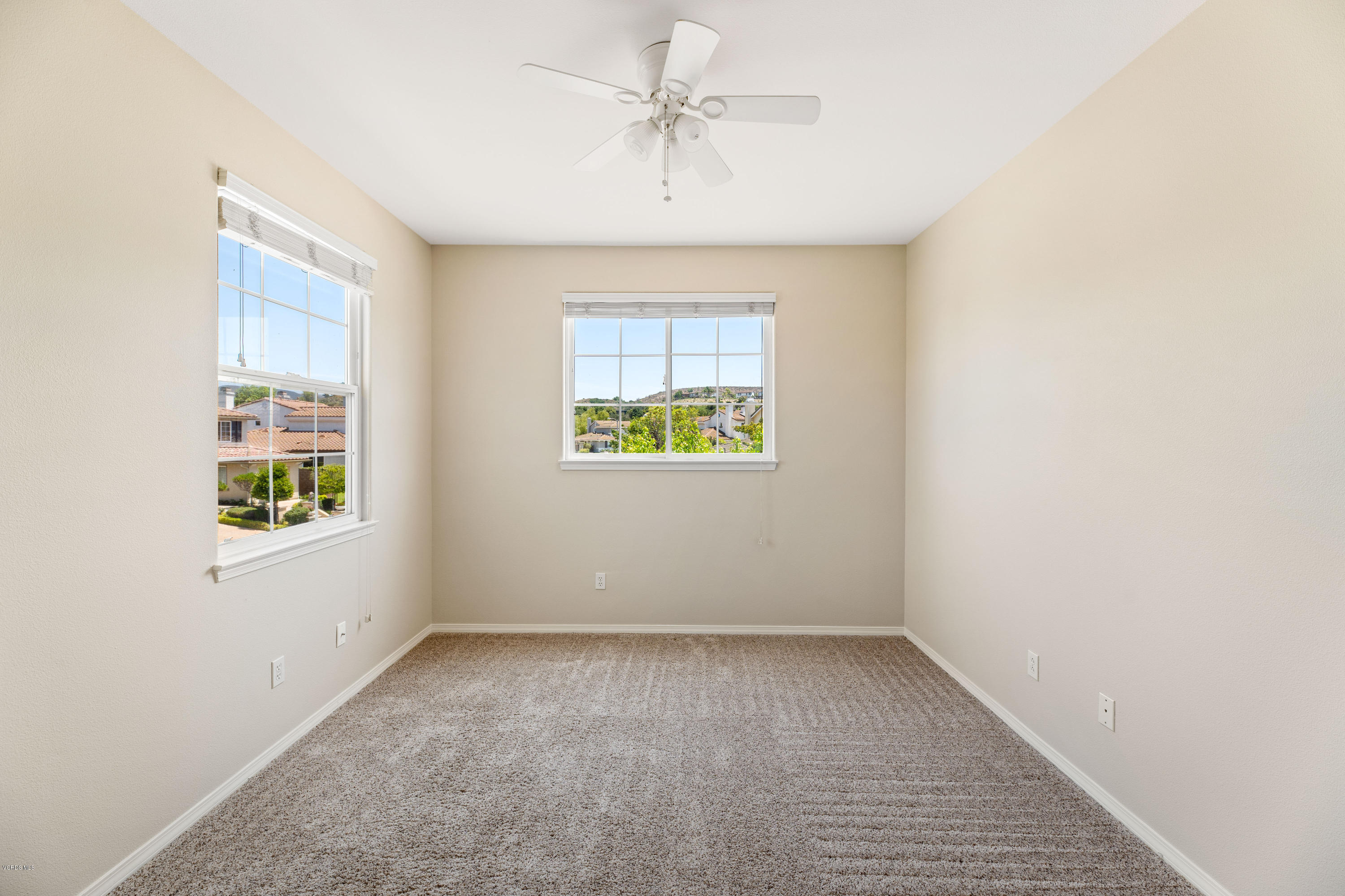 4591 Bluewood Court Moorpark, CA 93021 - Photo 12 of 43 an empty room with a window and a ceiling fan