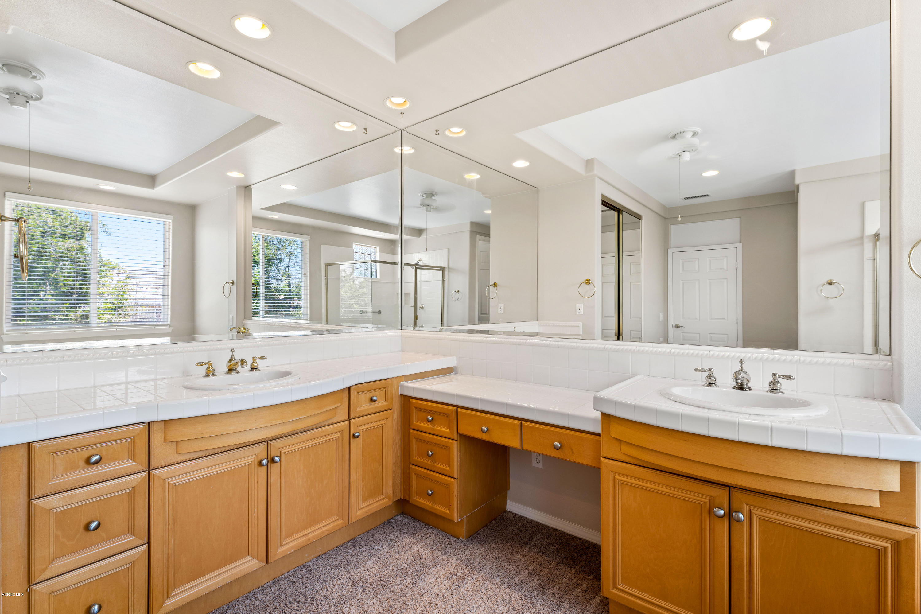 4591 Bluewood Court Moorpark, CA 93021 - Photo 16 of 43 a bathroom with a sink double vanity granite and a large mirror