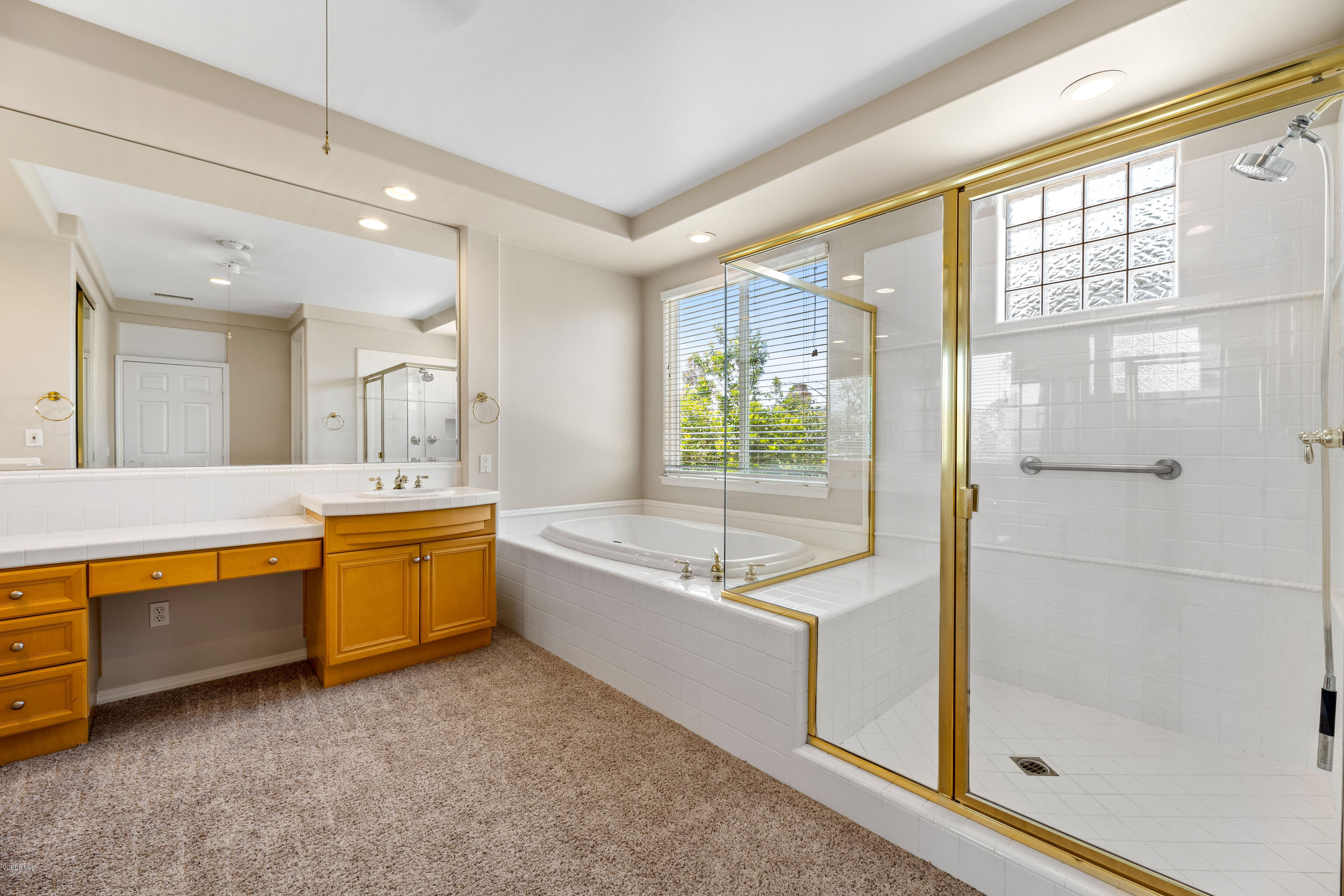 4591 Bluewood Court Moorpark, CA 93021 - Photo 17 of 43 a bathroom with a tub sink shower and mirror