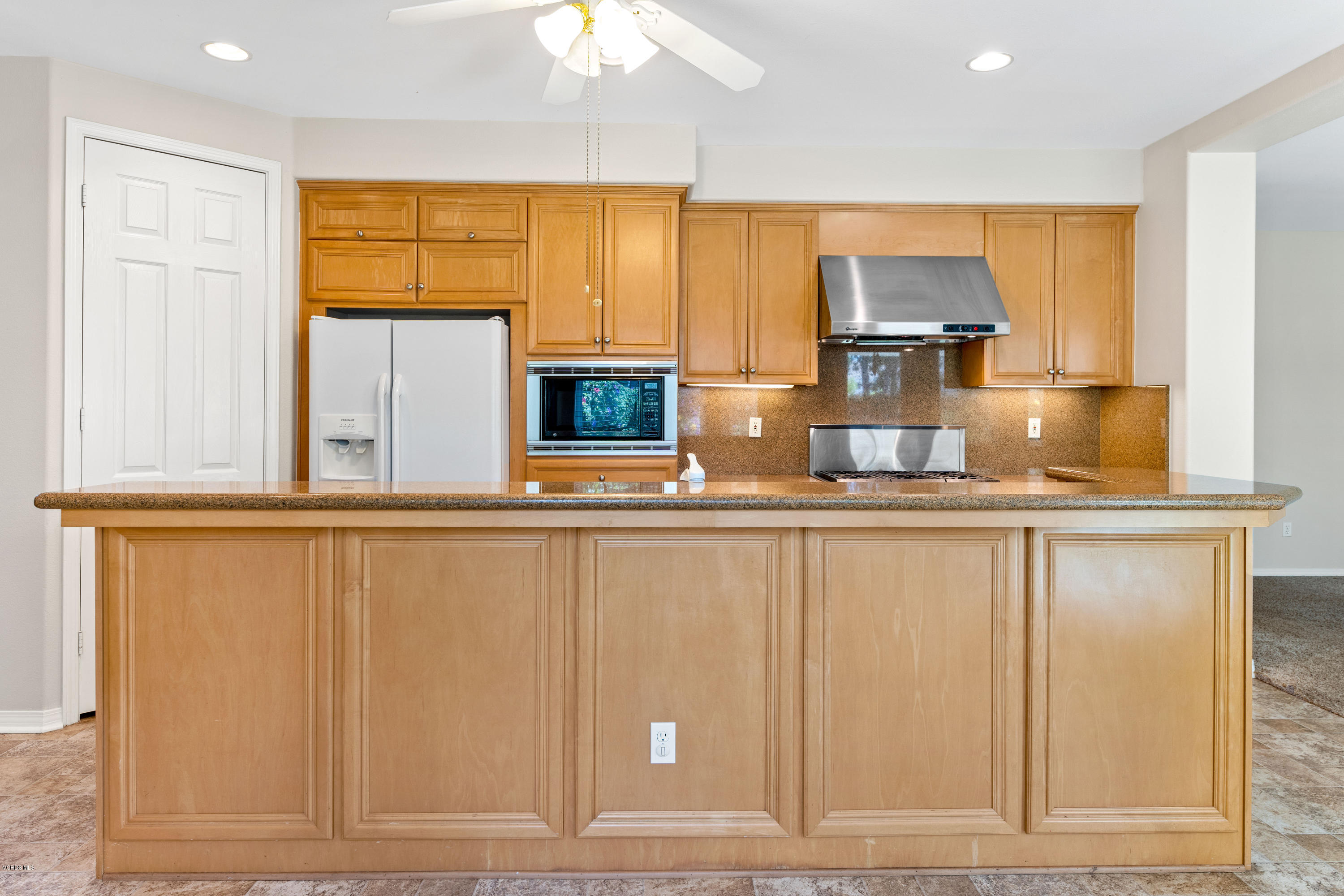 4591 Bluewood Court Moorpark, CA 93021 - Photo 23 of 43 a kitchen with stainless steel appliances granite countertop a refrigerator and cabinets