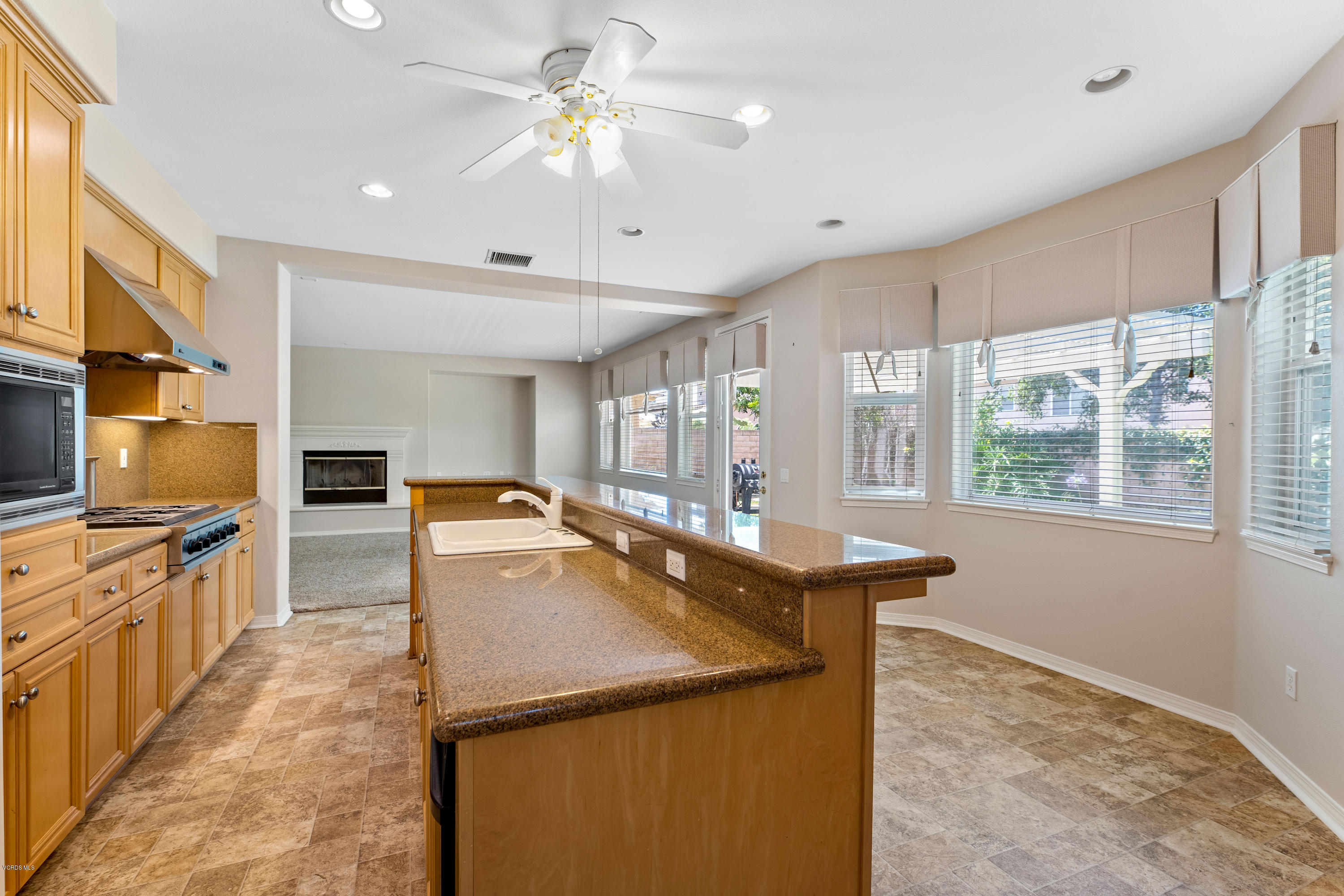 4591 Bluewood Court Moorpark, CA 93021 - Photo 24 of 43 a kitchen with kitchen island a counter top space appliances and a window