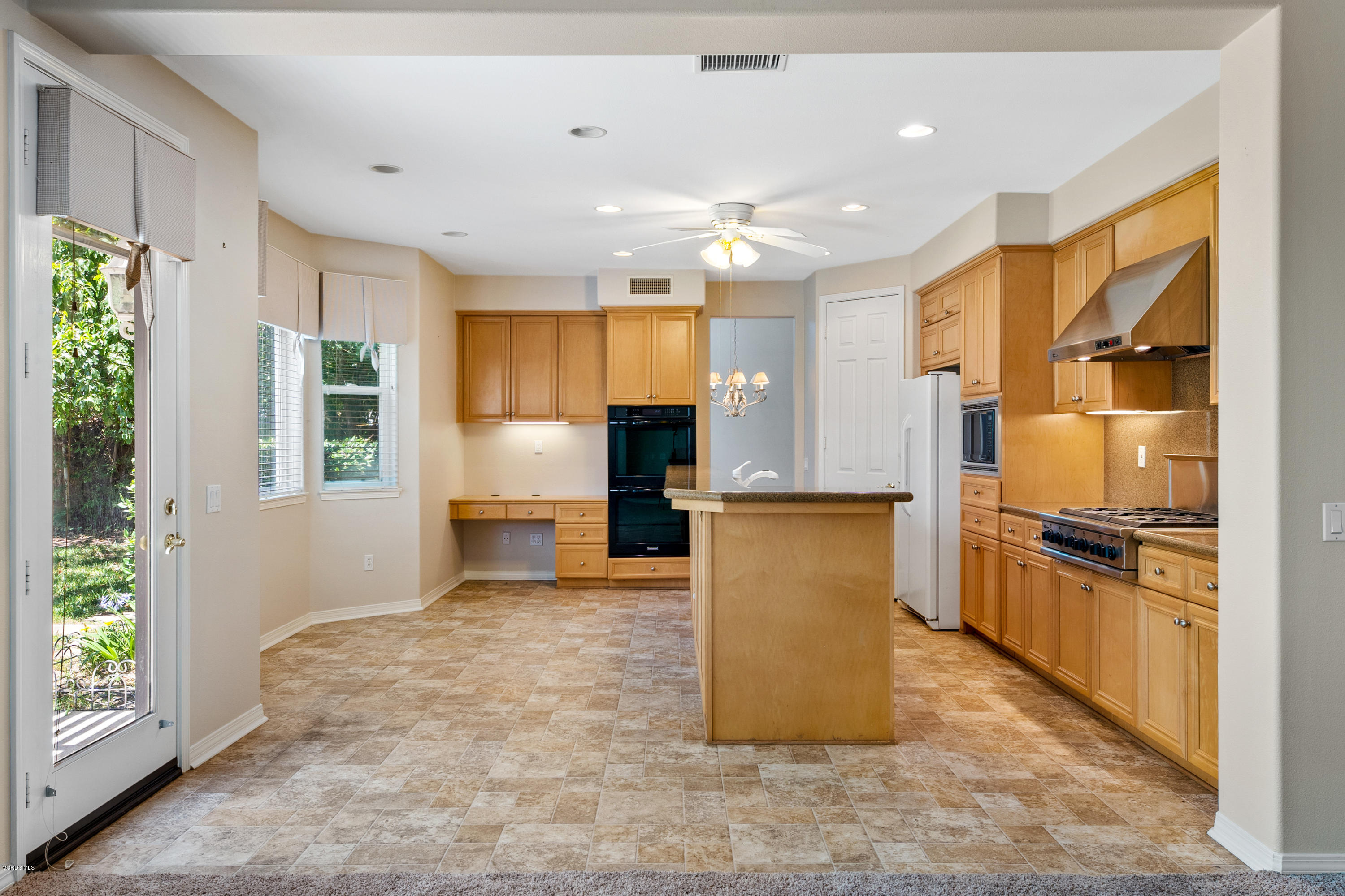 4591 Bluewood Court Moorpark, CA 93021 - Photo 27 of 43 a view of kitchen with kitchen island granite countertop a refrigerator stove top oven and sink