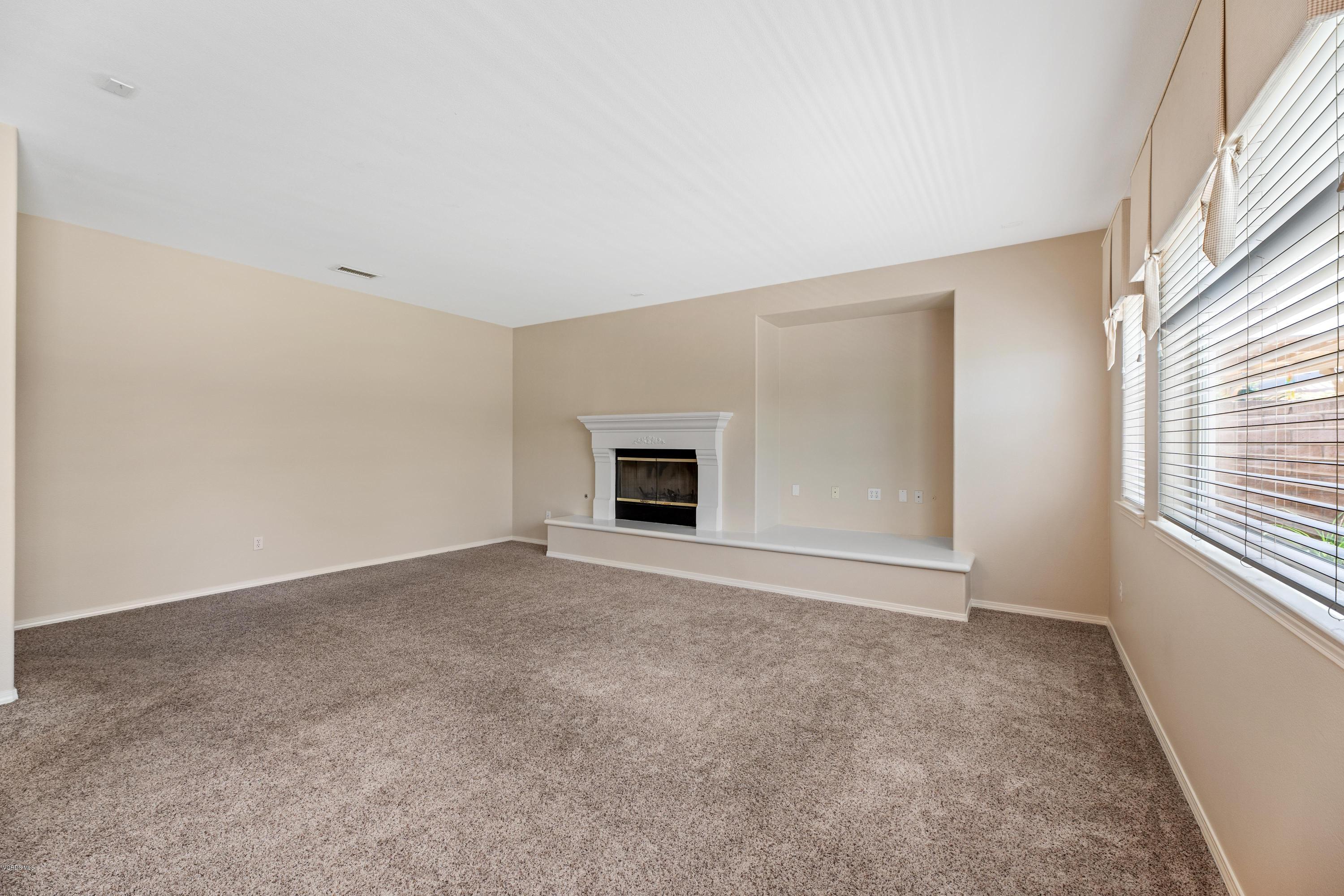 4591 Bluewood Court Moorpark, CA 93021 - Photo 28 of 43 a view of an empty room with a window and a fireplace