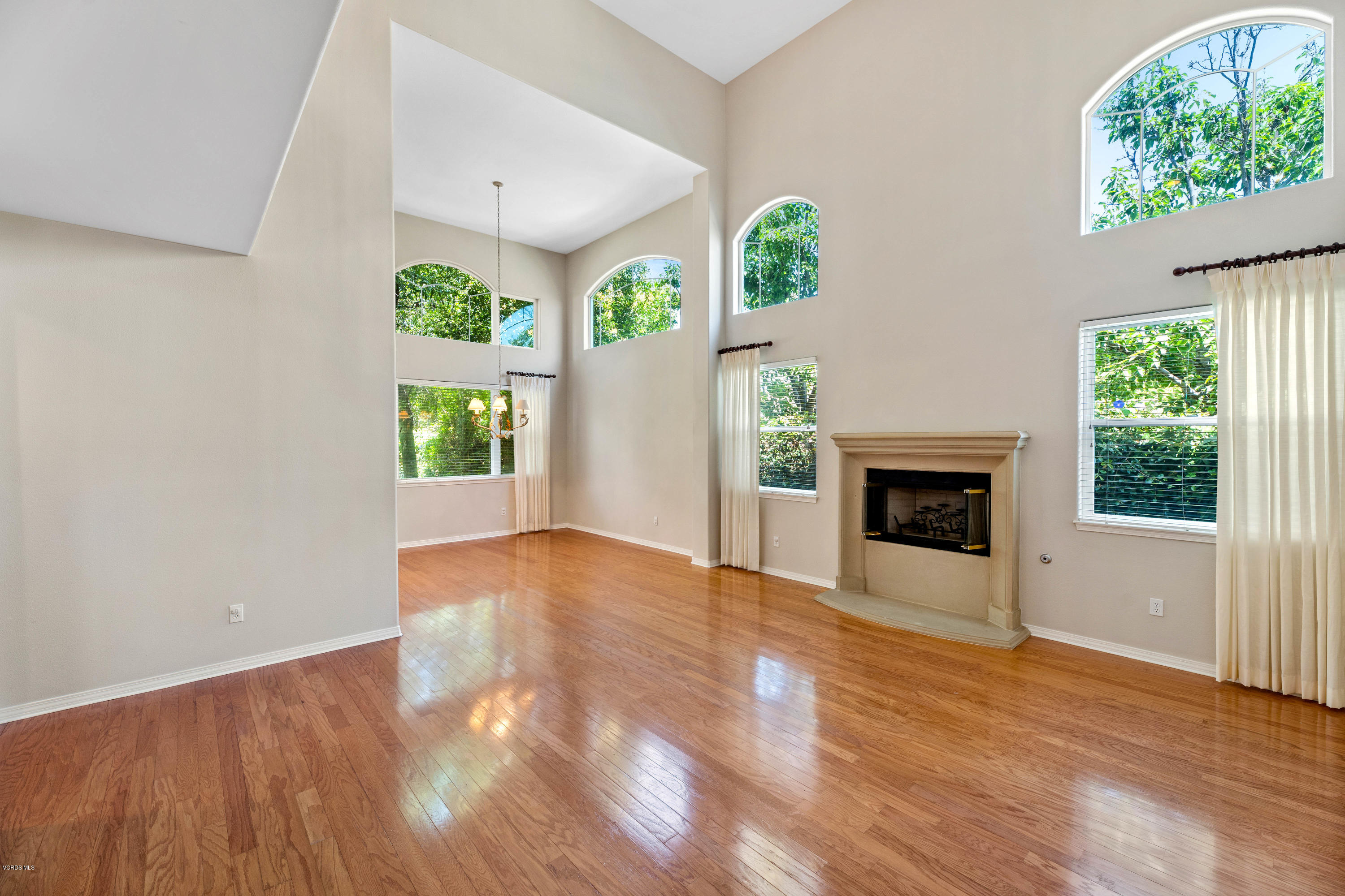 4591 Bluewood Court Moorpark, CA 93021 - Photo 4 of 43 an empty room with windows and fireplace
