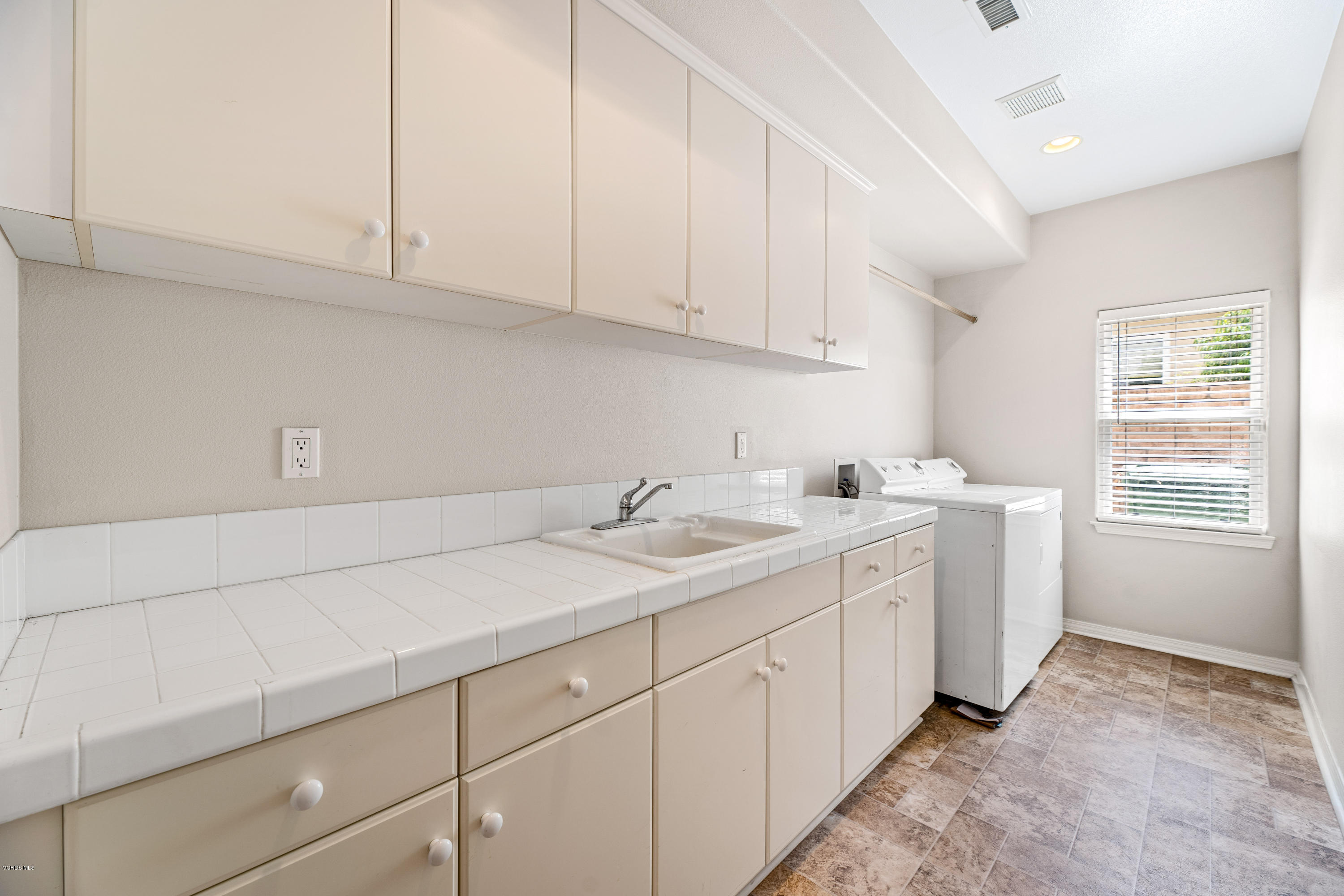 4591 Bluewood Court Moorpark, CA 93021 - Photo 31 of 43 a utility room with sink dryer and washer