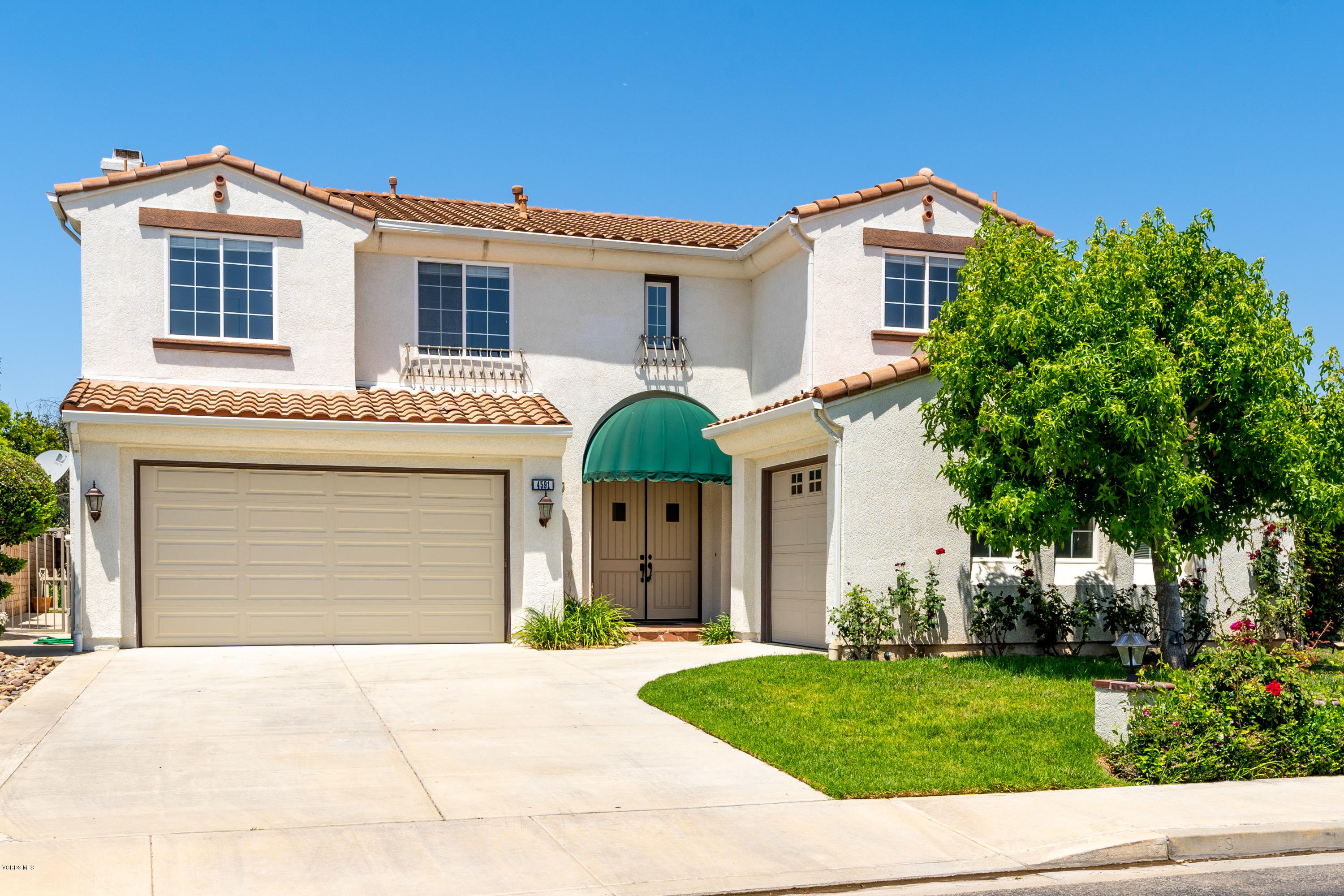 4591 Bluewood Court Moorpark, CA 93021 - Photo 36 of 43 a front view of a house with a yard and garage