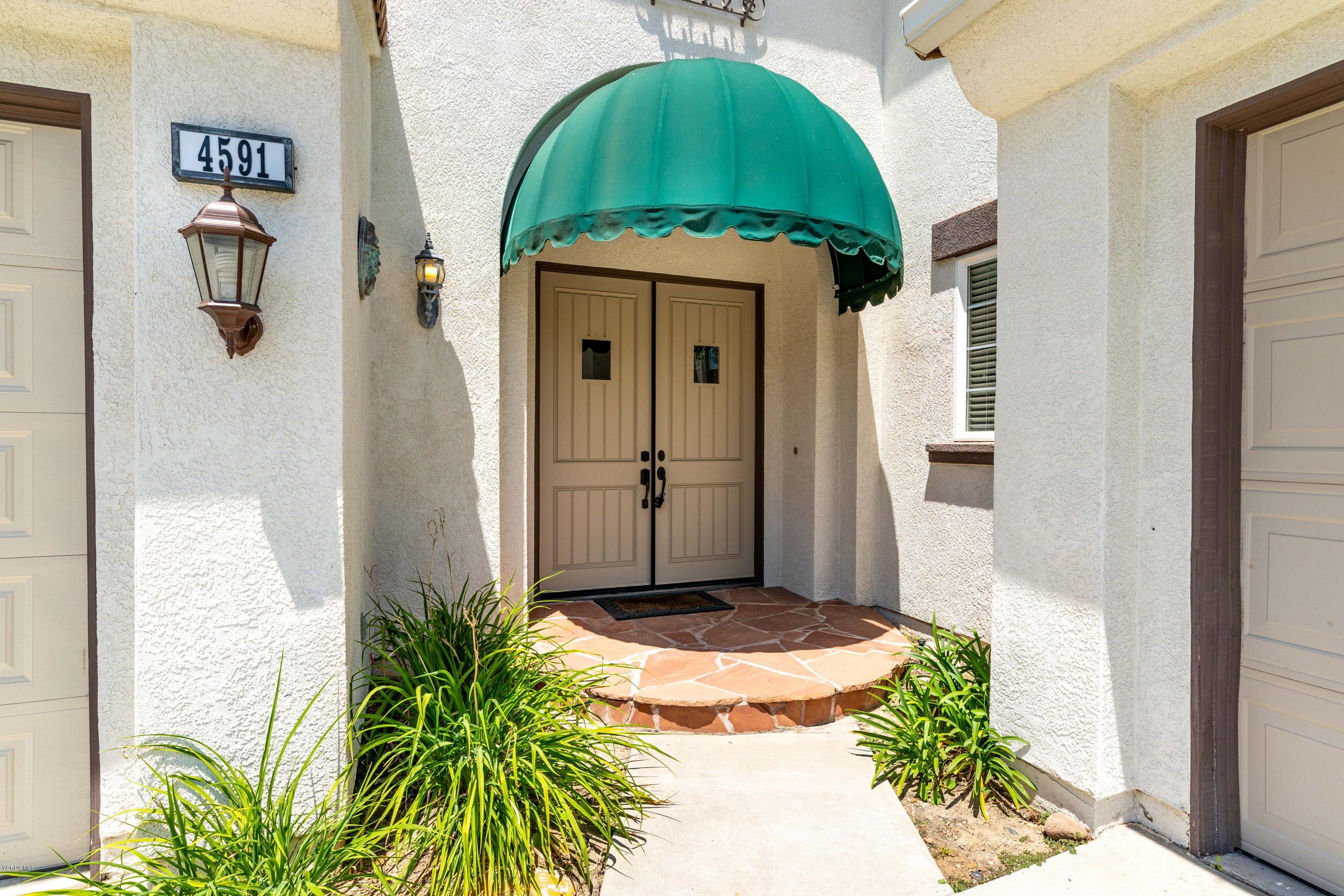 4591 Bluewood Court Moorpark, CA 93021 - Photo 37 of 43 a front view of a house with a garden