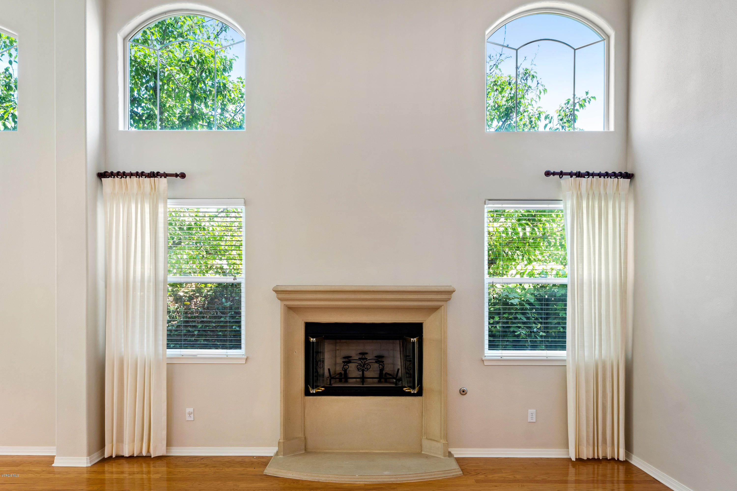 4591 Bluewood Court Moorpark, CA 93021 - Photo 5 of 43 a living room with a fireplace and a window