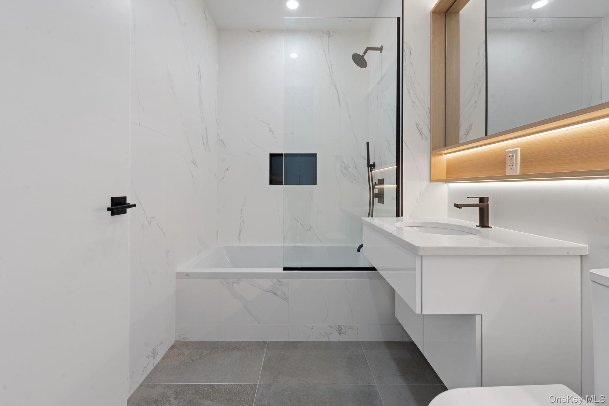 366 Harman Street, Unit 1F Brooklyn, NY 11237 - Photo 7 of 12 Full bathroom with a combined bath / shower with marble appearance and vanity