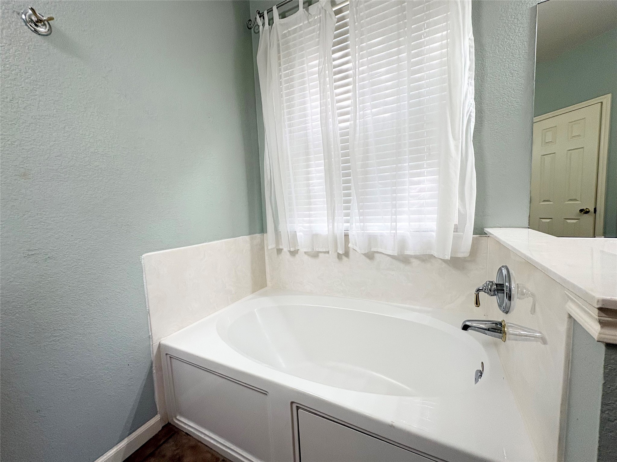 7006 Rambollet Terrace Round Rock, TX 78681 - Photo 21 of 38 Relax in this comfortable primary bathroom featuring a deep soaking tub and a window with natural light.