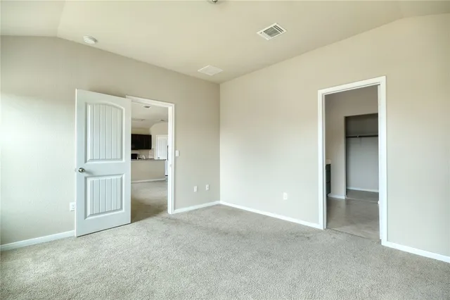 an empty room with closet and a window