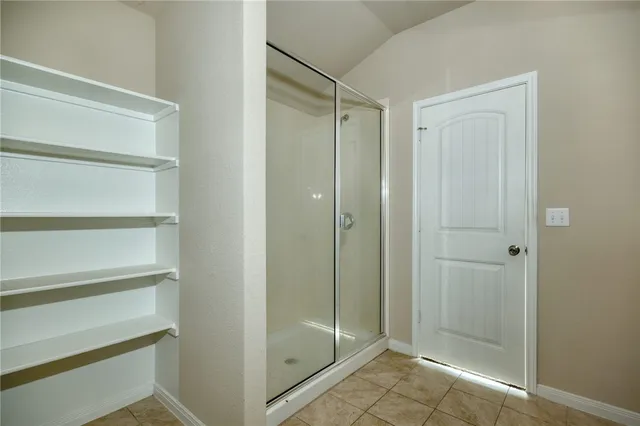 a bathroom with a glass shower door