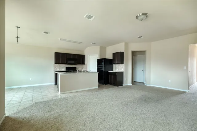 a kitchen with stainless steel appliances a refrigerator and a microwave