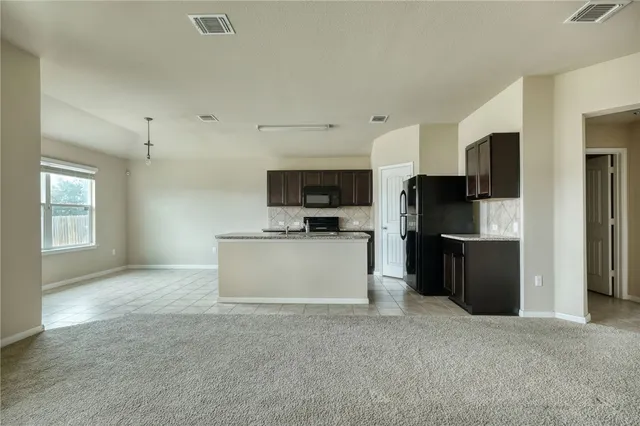 a large kitchen with cabinets and stainless steel appliances