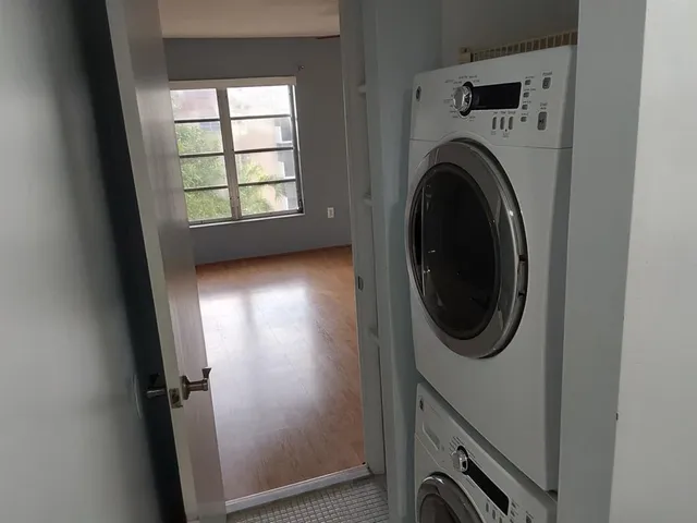 a view of a hallway with washer and dryer