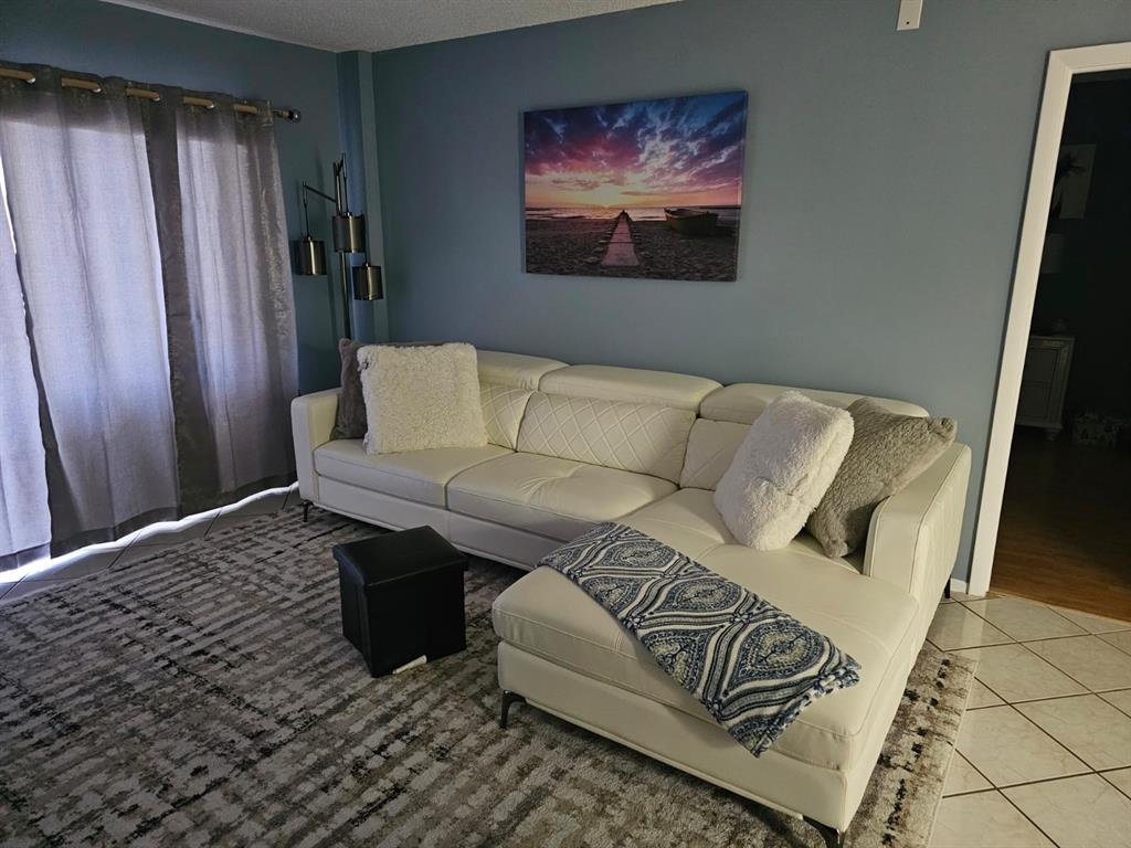 4166 Inverrary Drive Lauderhill, FL 33319 - Photo 10 of 11 a living room with furniture and a rug