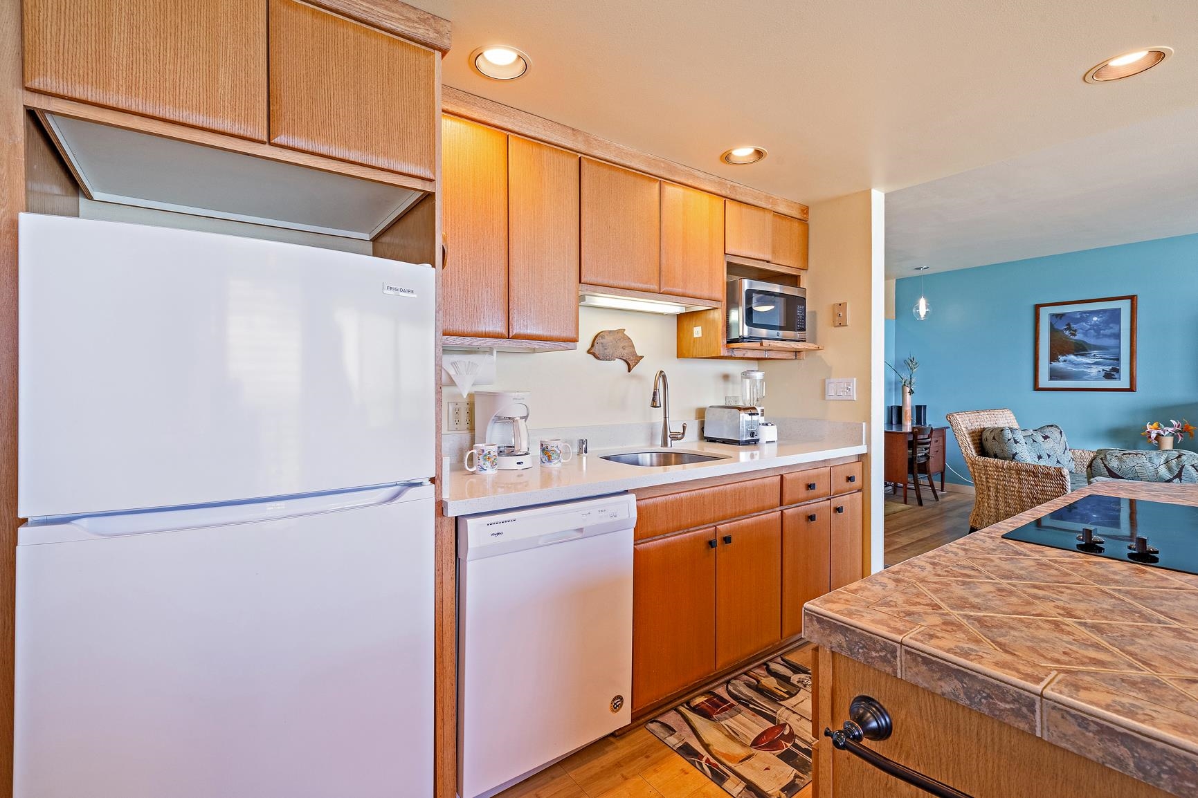 3559 Lower Honoapiilani Road, Unit 5G Lahaina, HI 96761 - Photo 15 of 42 a kitchen with stainless steel appliances granite countertop refrigerator sink and cabinets