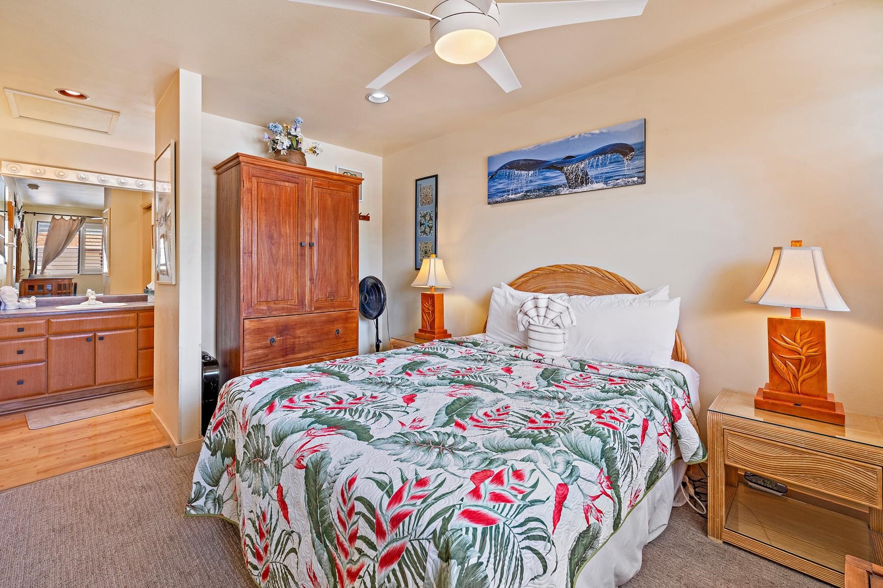 3559 Lower Honoapiilani Road, Unit 5G Lahaina, HI 96761 - Photo 25 of 42 a bedroom with a bed and a chandelier